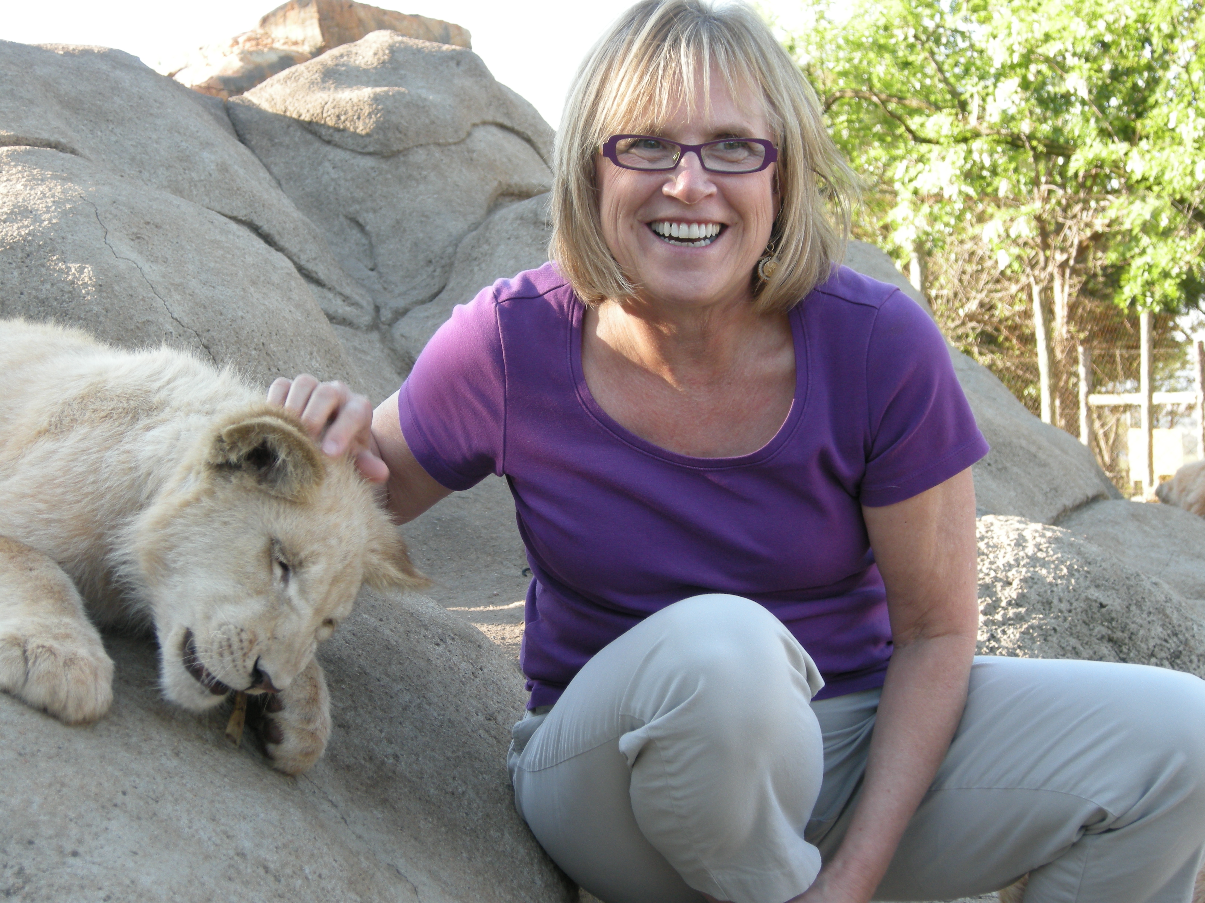 Jill scratching lion cub
