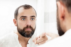 Man Looking in Mirror